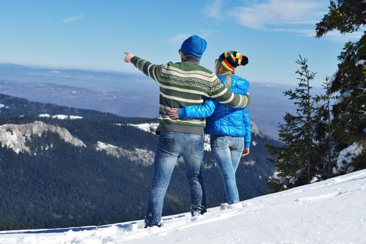 Young Couple In winter Snow Scene at  beautiful sunny day