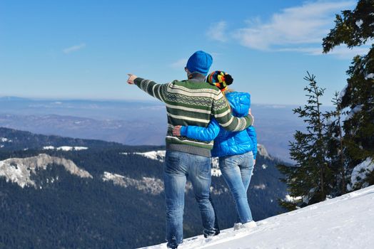 Young Couple In winter Snow Scene at  beautiful sunny day