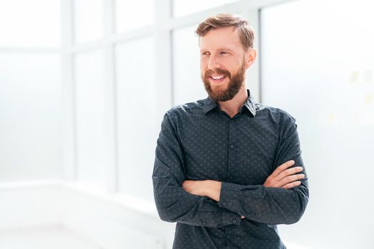 successful businessman standing near the office window. photo with copy space