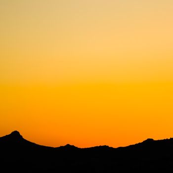 Background from a beautiful colorful sunset with the silhouette of the mountains. High quality photo