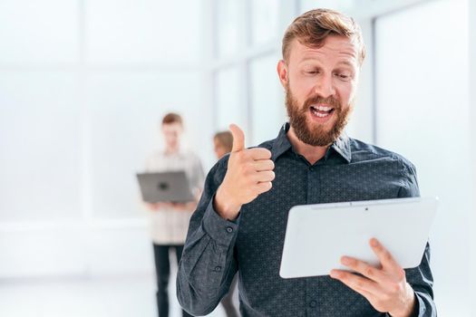 businessman with digital tablet showing thumb up. photo with copy space