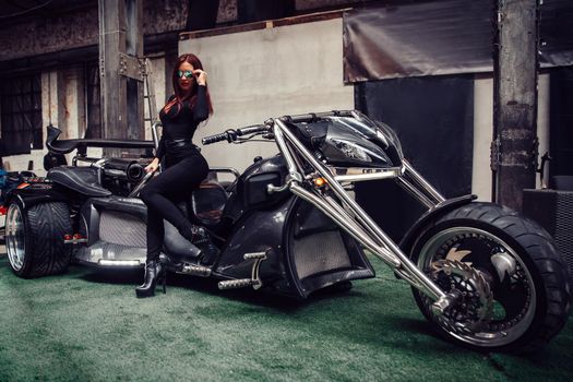 close up. stylish young woman model posing near a chic tricycle