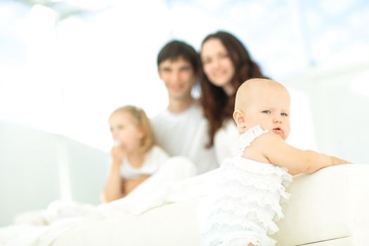 little baby on blurred background of the family.photo with copy space.the concept of parenthood