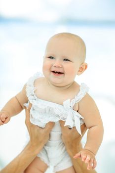 pretty baby in the arms of his father .photo with copy space