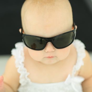 closeup.portrait of little baby with sunglasses. the concept of childhood