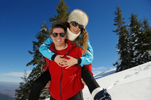 Young Couple In winter Snow Scene at  beautiful sunny day