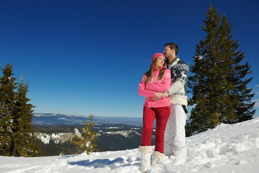 Young Couple In winter Snow Scene at  beautiful sunny day