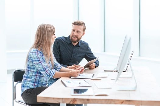 side view. two employees discussing financial documents. business concept