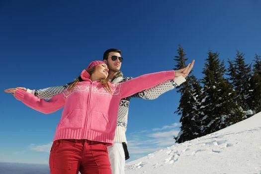 Young Couple In winter Snow Scene at  beautiful sunny day