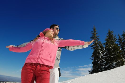 Young Couple In winter Snow Scene at  beautiful sunny day