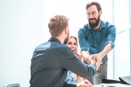 happy project Manager shaking hands with employee. photo with copy space