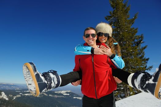 Young Couple In winter Snow Scene at  beautiful sunny day