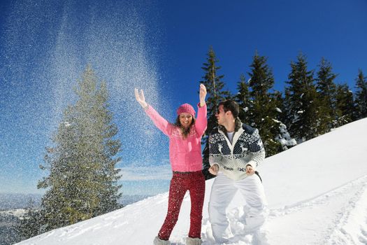 Young Couple In winter Snow Scene at  beautiful sunny day