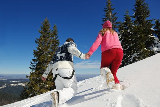 Young Couple In winter Snow Scene at  beautiful sunny day