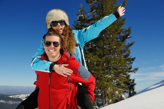 Young Couple In winter Snow Scene at  beautiful sunny day