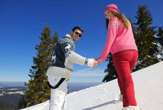 Young Couple In winter Snow Scene at  beautiful sunny day