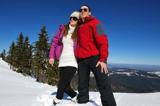 Young Couple In winter Snow Scene at  beautiful sunny day