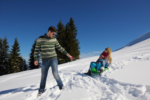 Winter season. Happy family having fun on fresh snow on vacation.