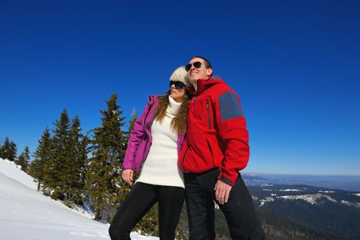 Young Couple In winter Snow Scene at  beautiful sunny day