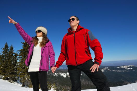 Young Couple In winter Snow Scene at  beautiful sunny day