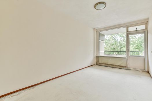 Empty room with big window and radiator