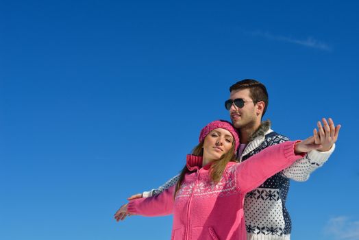 Young Couple In winter Snow Scene at  beautiful sunny day