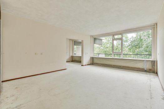 Empty room with big window and radiator