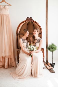 bridesmaid with a wedding bouquet sitting in a vintage chair. photo with copy space