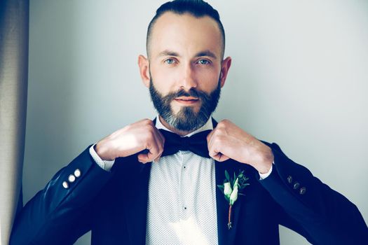 close up. confident man straightening his bow tie. people and events