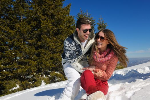 Young Couple In winter Snow Scene at  beautiful sunny day