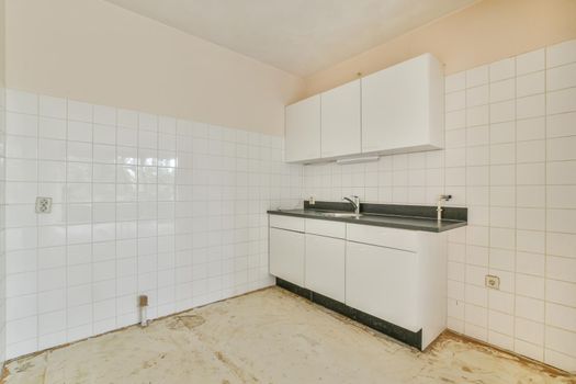 Miniature kitchen with black worktop in an elegant apartment