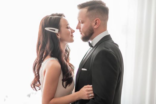close up. happy bride and groom looking at each other. holidays and events