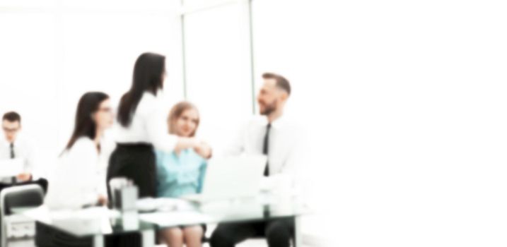 blurred image for the advertising text. image of a business office on a working day. concept of cooperation
