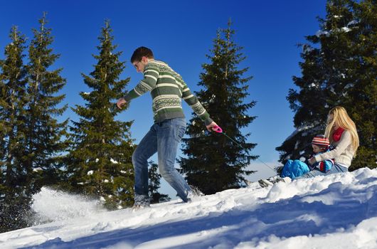 Winter season. Happy family having fun on fresh snow on vacation.