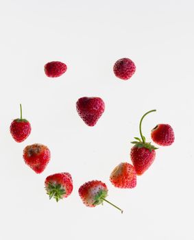 strawberries arranged on a lightbox in the shape of a smiley face
