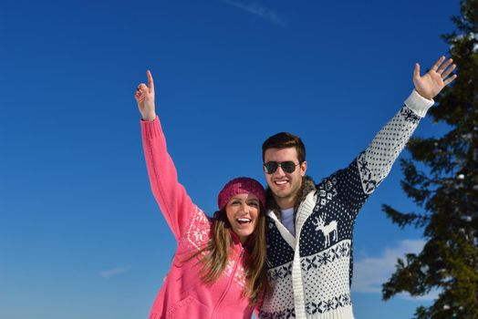 Young Couple In winter Snow Scene at  beautiful sunny day