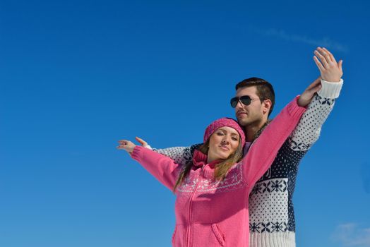 Young Couple In winter Snow Scene at  beautiful sunny day