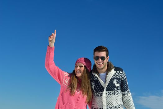 Young Couple In winter Snow Scene at  beautiful sunny day