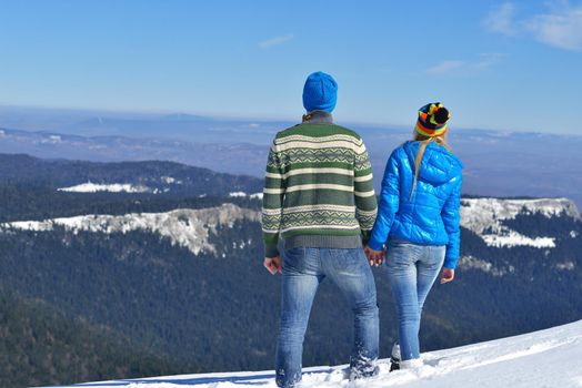 Young Couple In winter Snow Scene at  beautiful sunny day