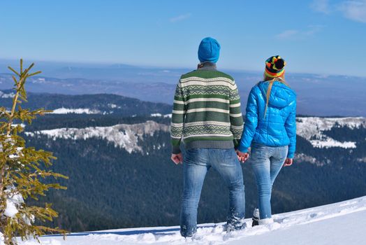 Young Couple In winter Snow Scene at  beautiful sunny day