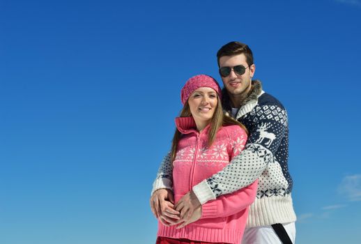 Young Couple In winter Snow Scene at  beautiful sunny day