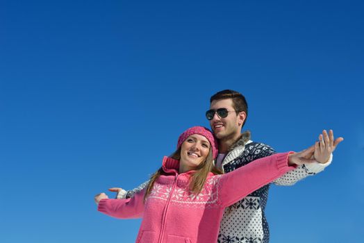 Young Couple In winter Snow Scene at  beautiful sunny day