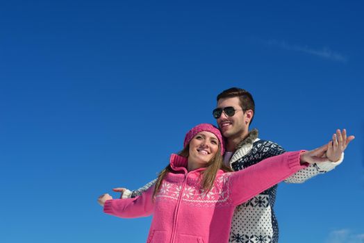 Young Couple In winter Snow Scene at  beautiful sunny day