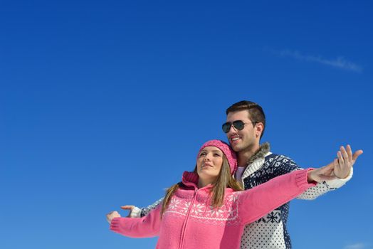 Young Couple In winter Snow Scene at  beautiful sunny day