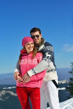 Young Couple In winter Snow Scene at  beautiful sunny day