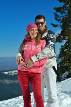 Young Couple In winter Snow Scene at  beautiful sunny day