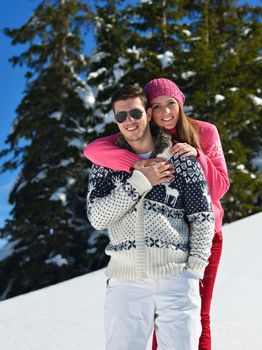 Young Couple In winter Snow Scene at  beautiful sunny day