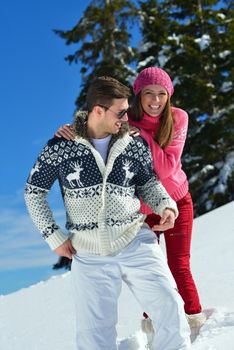 Young Couple In winter Snow Scene at  beautiful sunny day