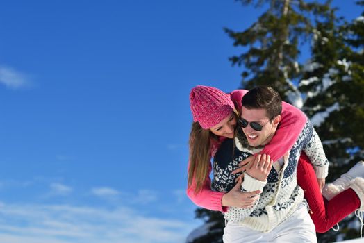 Young Couple In winter Snow Scene at  beautiful sunny day