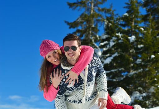 Young Couple In winter Snow Scene at  beautiful sunny day